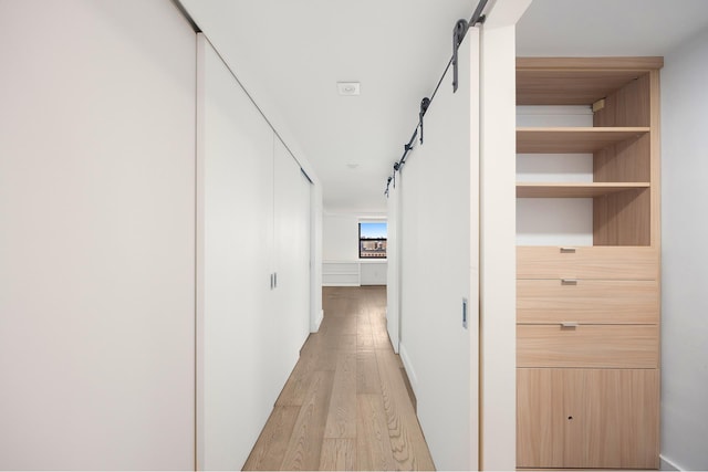 135 W 70th St Unit 10C, New York City, NY 10023 - corridor with a barn door and light wood-style floors