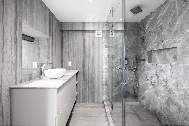135 W 70th St Unit 10C, New York City, NY 10023 - bathroom featuring a marble finish shower and vanity