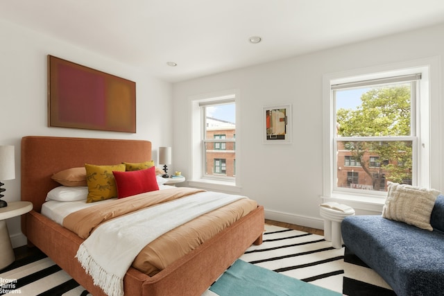 10 Hancock St, New York City, NY 11216 - bedroom featuring multiple windows, light wood-style flooring, and recessed lighting