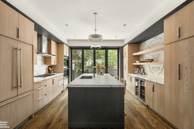 10 Hancock St, New York City, NY 11216 - kitchen featuring wall chimney exhaust hood, wine cooler, an island with sink, open shelves, and light brown cabinetry