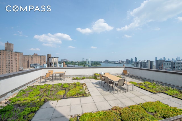 353 E 104th St Unit 2F, New York City, NY 10029 - view of patio / terrace featuring a view of skyline, a water view, and outdoor dining area