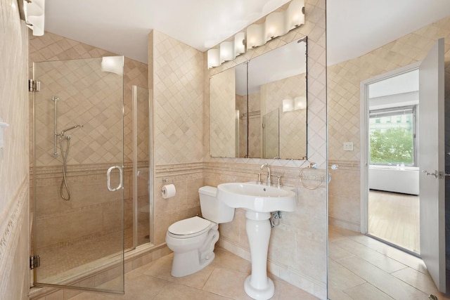 180 Park Row Unit 5B, New York City, NY 10038 - bathroom featuring tile walls, a stall shower, and tile patterned flooring