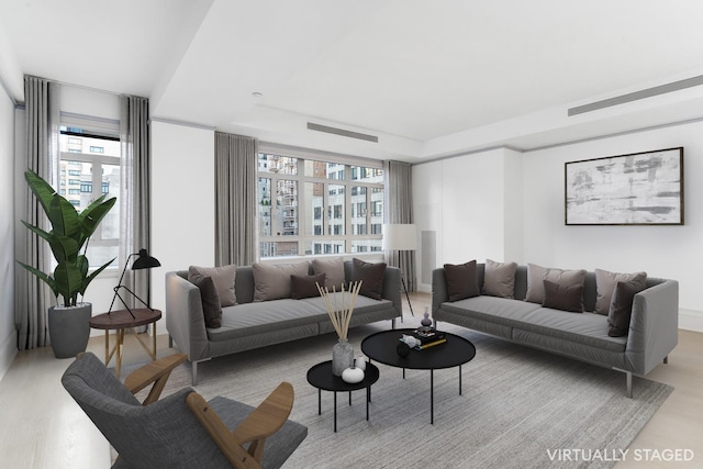 21 E 61st St Unit 9C, New York City, NY 10065 - living area featuring a tray ceiling and plenty of natural light