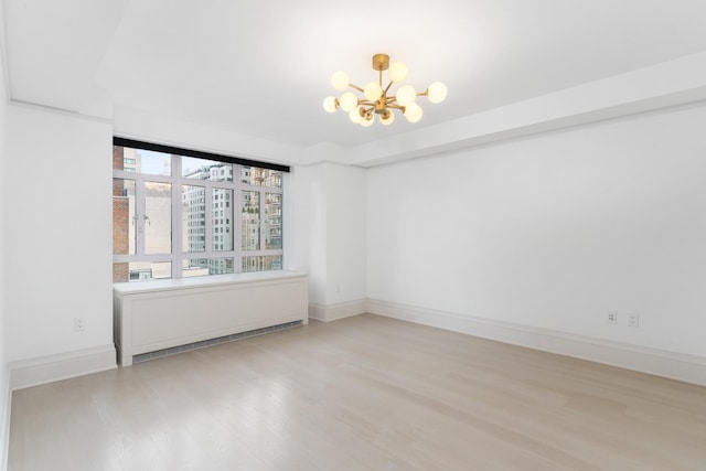 21 E 61st St Unit 9C, New York City, NY 10065 - unfurnished room featuring a chandelier and wood finished floors