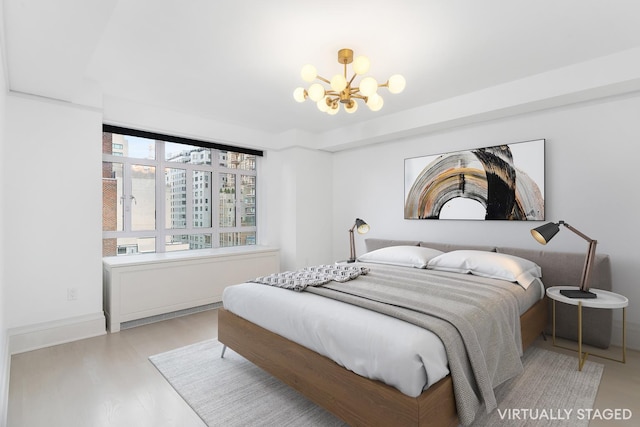 21 E 61st St Unit 9C, New York City, NY 10065 - bedroom featuring a chandelier and wood finished floors