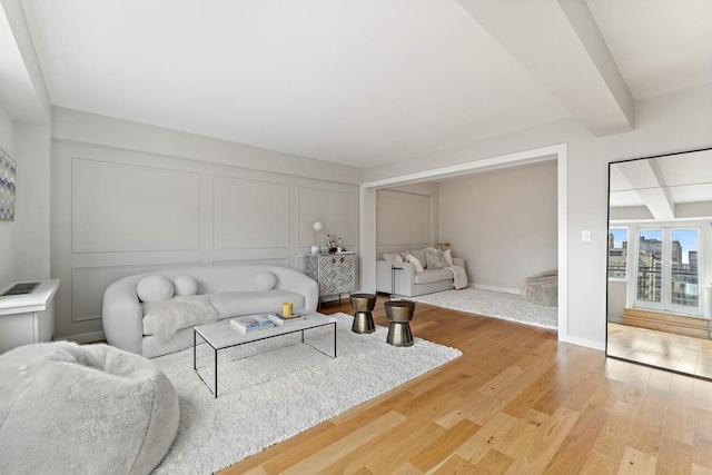 20 E 68th St Unit 12D, New York City, NY 10065 - living room featuring a decorative wall and light wood-style flooring