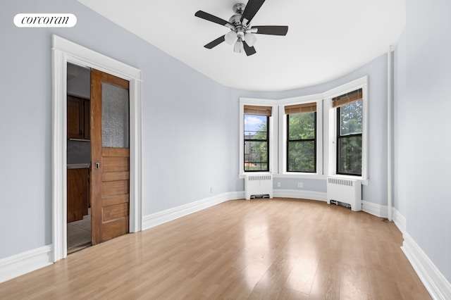 59-26 Catalpa Ave, New York City, NY 11385 - empty room with radiator, wood finished floors, and a ceiling fan