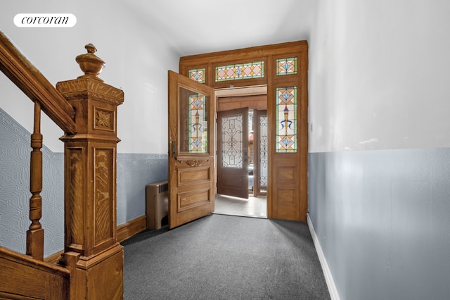59-26 Catalpa Ave, New York City, NY 11385 - carpeted foyer featuring radiator and baseboards