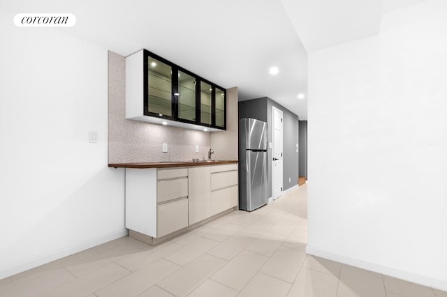 59-26 Catalpa Ave, New York City, NY 11385 - kitchen with freestanding refrigerator, backsplash, recessed lighting, and glass insert cabinets