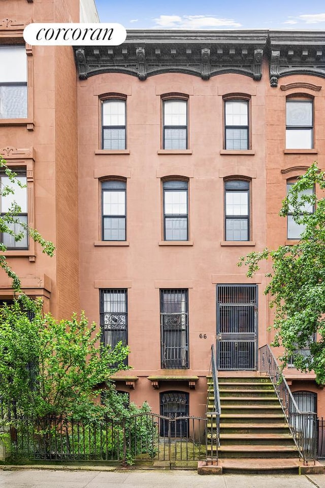 66 Putnam Ave, New York City, NY 11238 - view of building exterior with a fenced front yard