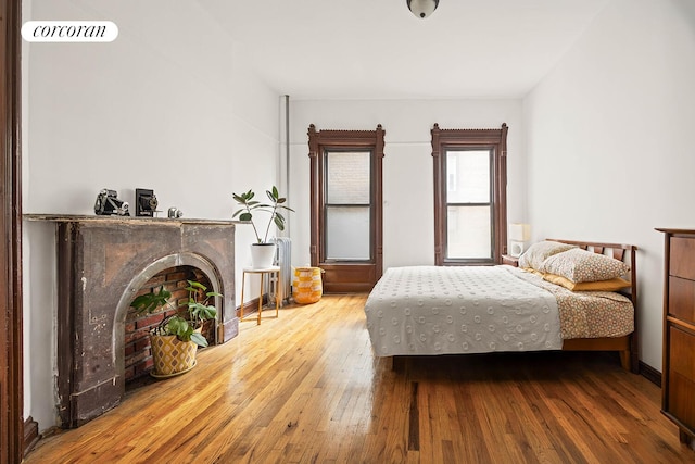 66 Putnam Ave, New York City, NY 11238 - bedroom with wood-type flooring and a fireplace