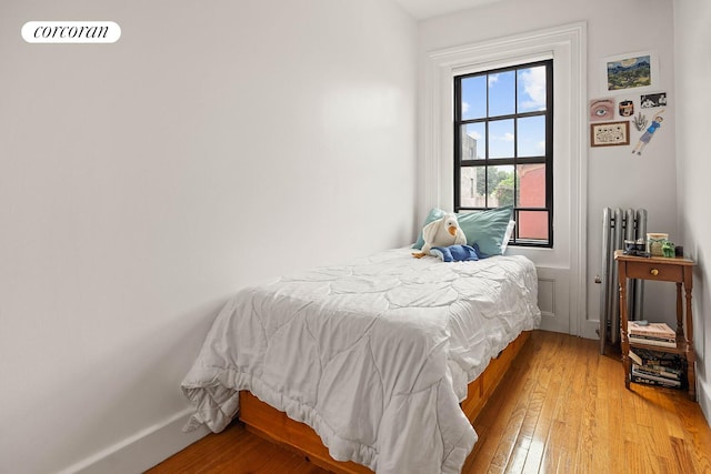 66 Putnam Ave, New York City, NY 11238 - bedroom featuring light wood-style flooring and radiator