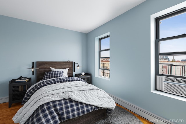 299 13th St Unit 4B, New York City, NY 11215 - bedroom with a baseboard radiator and wood finished floors