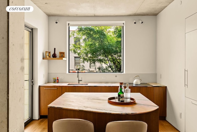 450 Warren St Unit 2C, New York City, NY 11217 - kitchen featuring brown cabinets, modern cabinets, light wood-style flooring, and light countertops