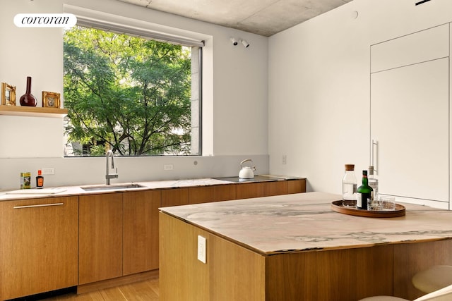 450 Warren St Unit 2C, New York City, NY 11217 - kitchen featuring light wood-type flooring, brown cabinetry, open shelves, and modern cabinets