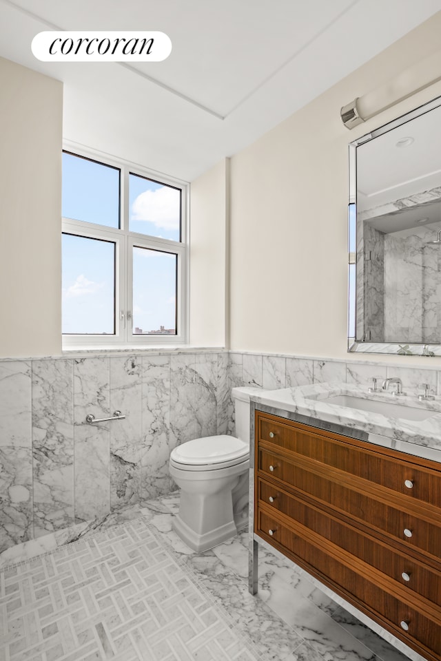 100 Claremont Ave Unit 12D, New York City, NY 10027 - bathroom with tile walls, vanity, wainscoting, and marble finish floors