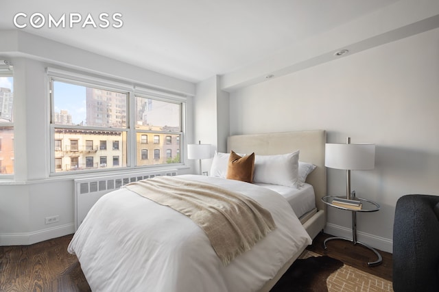 166 E 35th St Unit 5F, New York City, NY 10016 - bedroom featuring radiator and wood finished floors