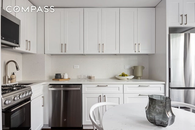 166 E 35th St Unit 5F, New York City, NY 10016 - kitchen featuring appliances with stainless steel finishes, light countertops, and white cabinets