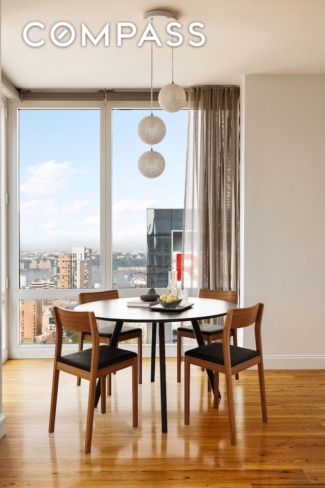 247 W 46th St Unit 3103, New York City, NY 10036 - dining space with light wood-style flooring and a city view