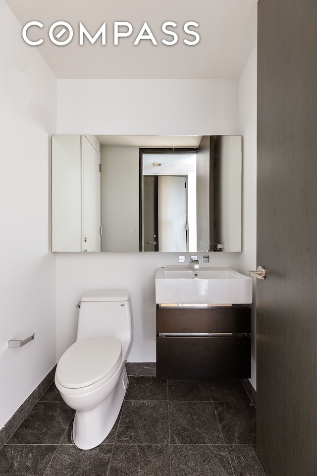 247 W 46th St Unit 3103, New York City, NY 10036 - half bathroom featuring vanity and toilet
