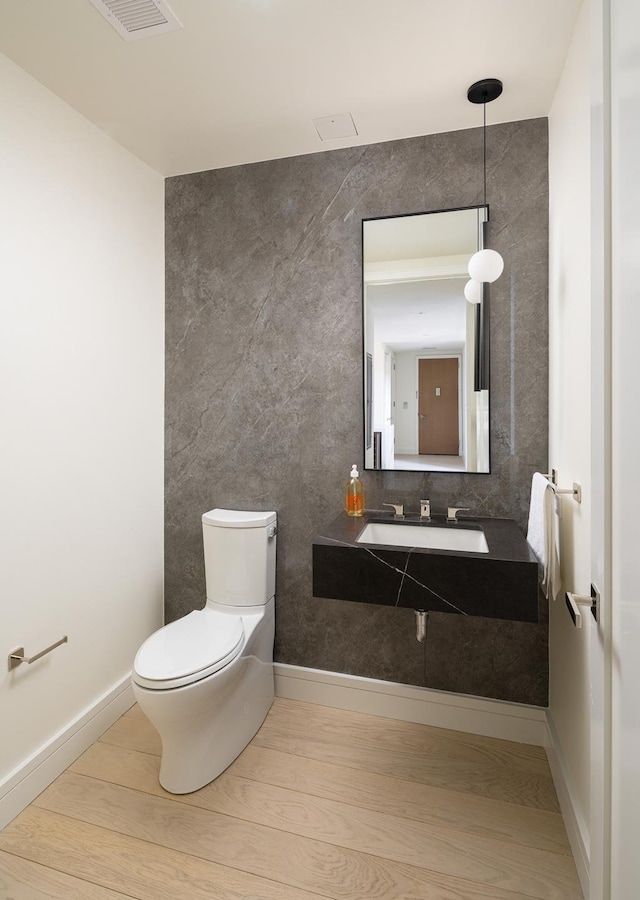 200 E 20th St Unit 15B, New York City, NY 10003 - half bathroom featuring tile walls and wood finished floors