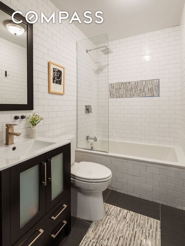 161 Jackson St Unit 1, New York City, NY 11211 - bathroom with tile walls, vanity, tile patterned flooring, tiled shower / bath, and backsplash
