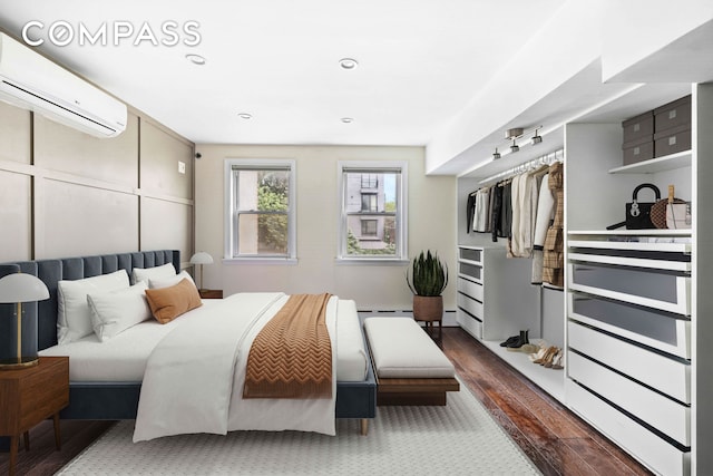 170 Skillman Ave, New York City, NY 11211 - bedroom featuring an AC wall unit, wood finished floors, and recessed lighting