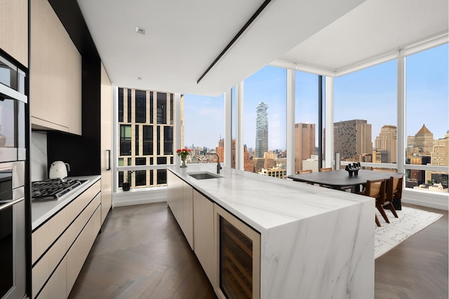 111 Murray St Unit 30A, New York City, NY 10007 - kitchen with modern cabinets, beverage cooler, a skyline view, and stainless steel appliances