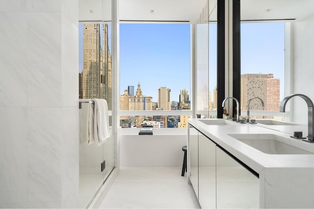 111 Murray St Unit 30A, New York City, NY 10007 - kitchen featuring modern cabinets, a view of skyline, white cabinetry, light countertops, and expansive windows