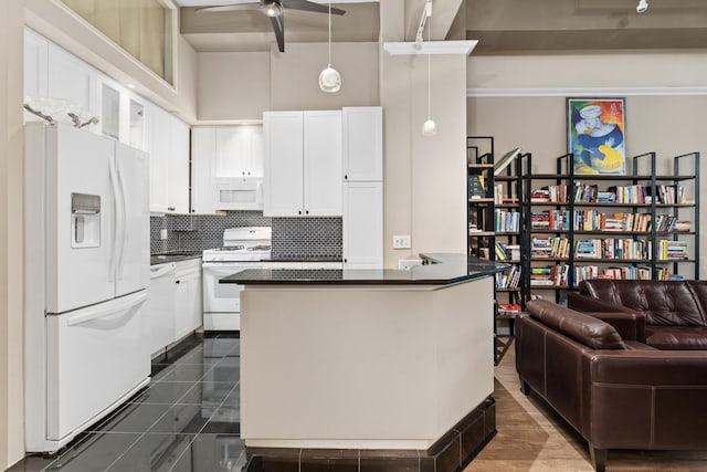 310 E 46th St Unit 4L, New York City, NY 10017 - kitchen with white appliances, dark countertops, a ceiling fan, white cabinetry, and backsplash