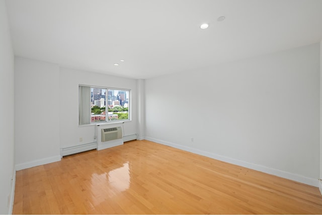 378 Baltic St Unit 9C, New York City, NY 11201 - unfurnished room featuring light wood-type flooring, an AC wall unit, recessed lighting, a baseboard radiator, and baseboard heating