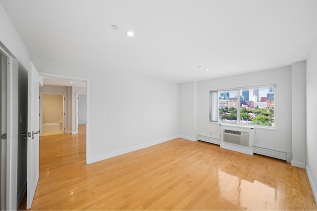 378 Baltic St Unit 9C, New York City, NY 11201 - empty room with a wall mounted AC, baseboard heating, light wood-style floors, and recessed lighting