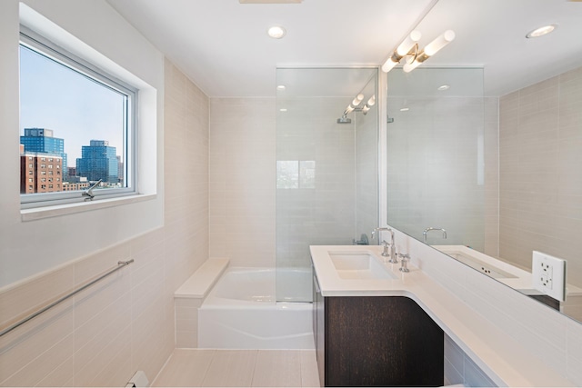 378 Baltic St Unit 9C, New York City, NY 11201 - bathroom with tile walls, a tub to relax in, vanity, and recessed lighting
