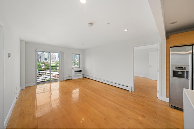 378 Baltic St Unit 9C, New York City, NY 11201 - unfurnished room with a baseboard heating unit, light wood-type flooring, recessed lighting, a wall mounted air conditioner, and a smoke detector