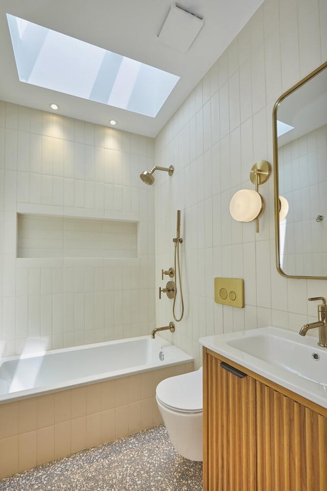 824A Quincy St, New York City, NY 11221 - bathroom featuring tile walls, a skylight, tiled shower / bath combo, vanity, and speckled floor
