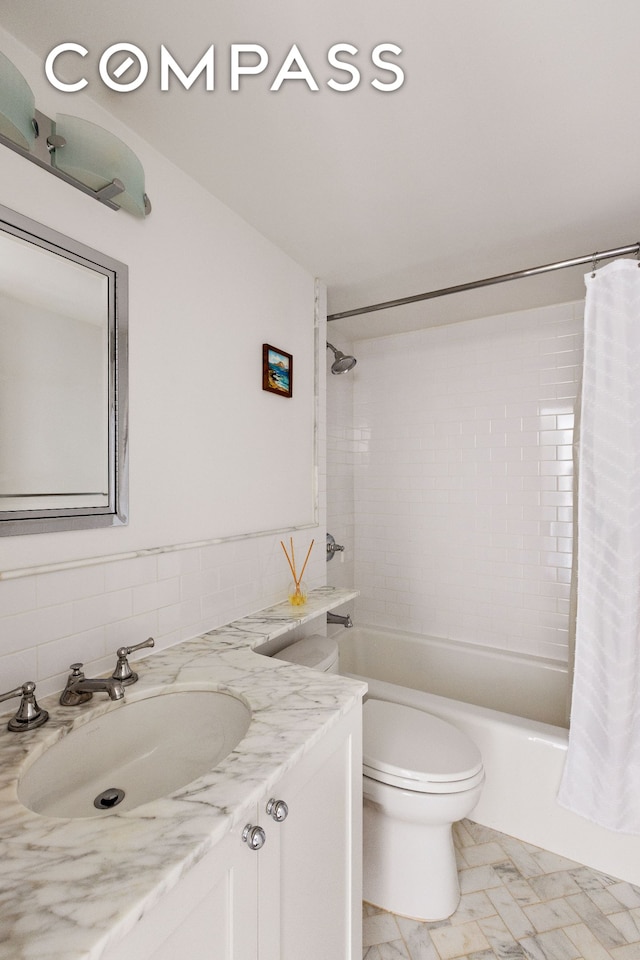 2 5th Ave Unit 5F, New York City, NY 10011 - bathroom featuring vanity, shower / tub combo, and tile walls