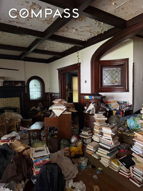 202 Marlborough Rd, New York City, NY 11226 - miscellaneous room featuring beam ceiling, a fireplace, wainscoting, coffered ceiling, and wood finished floors