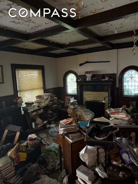 202 Marlborough Rd, New York City, NY 11226 - miscellaneous room with coffered ceiling, a wainscoted wall, healthy amount of natural light, beam ceiling, and a brick fireplace