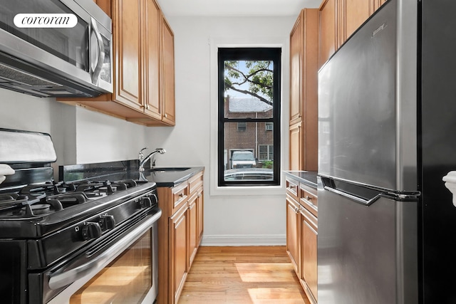 1485 E 16th St Unit 1J, New York City, NY 11230 - kitchen featuring stainless steel appliances, light wood finished floors, and brown cabinets