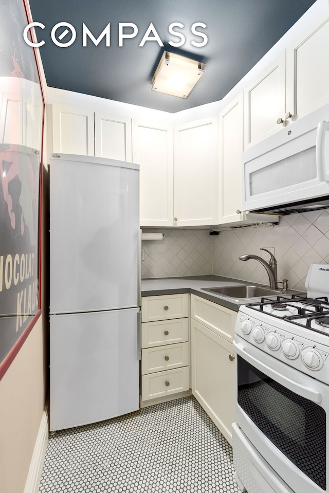 235 W 102nd St Unit 3B, New York City, NY 10025 - kitchen with white appliances, decorative backsplash, and white cabinets