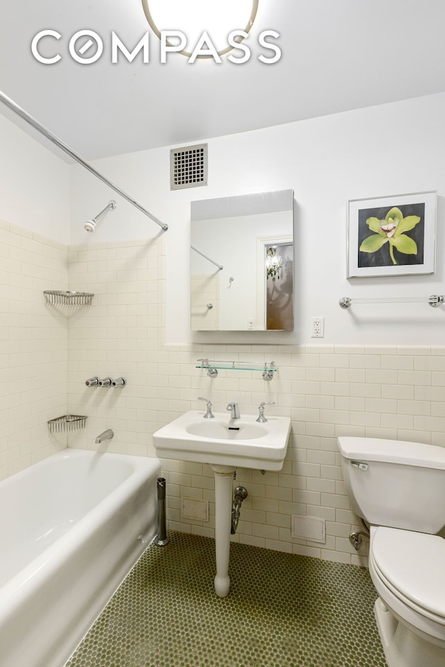 235 W 102nd St Unit 3B, New York City, NY 10025 - full bath with tub / shower combination, tile walls, tile patterned flooring, and wainscoting