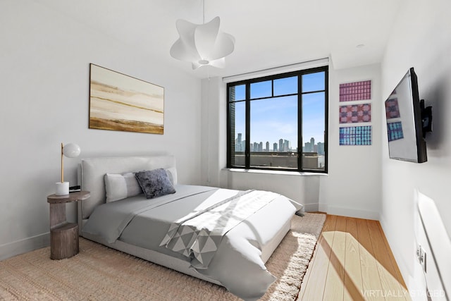 110 Charlton St Unit 17C, New York City, NY 10014 - bedroom featuring wood finished floors and baseboards