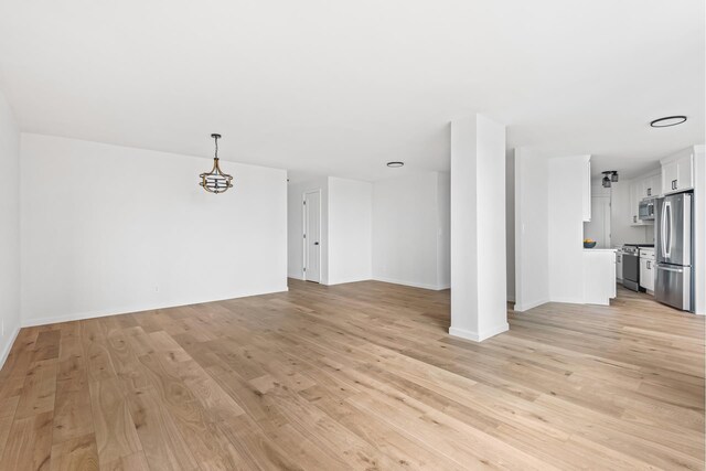 1655 Flatbush Ave Unit B1812, New York City, NY 11210 - unfurnished living room featuring light wood-style floors and a chandelier