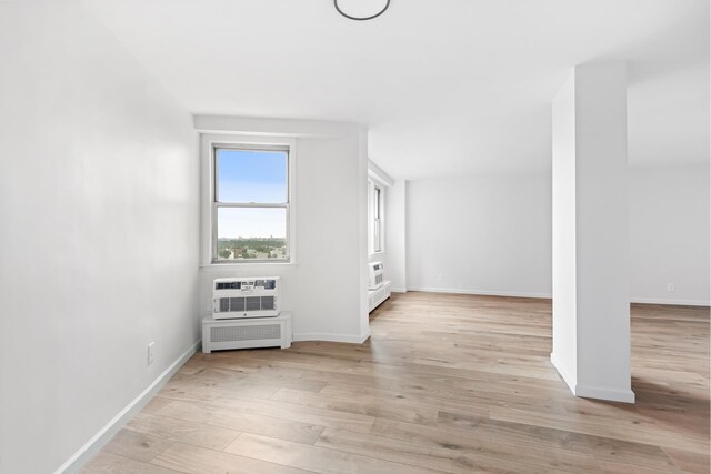 1655 Flatbush Ave Unit B1812, New York City, NY 11210 - additional living space featuring light wood-style floors, radiator, and a wall mounted air conditioner