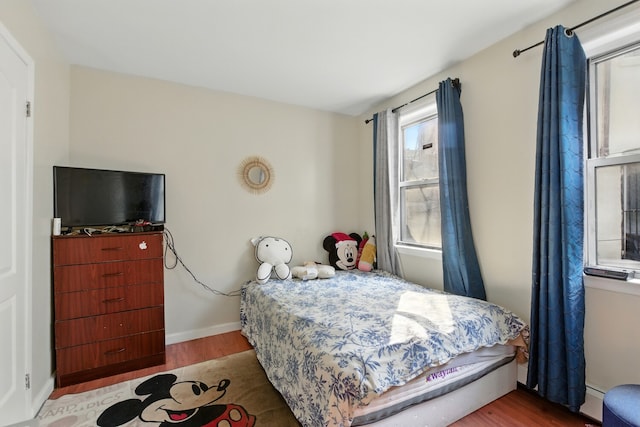 2517 Boston Rd, New York City, NY 10467 - bedroom featuring wood finished floors and a baseboard radiator