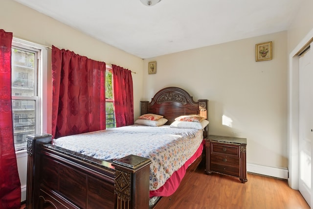 2517 Boston Rd, New York City, NY 10467 - bedroom featuring baseboard heating and wood finished floors