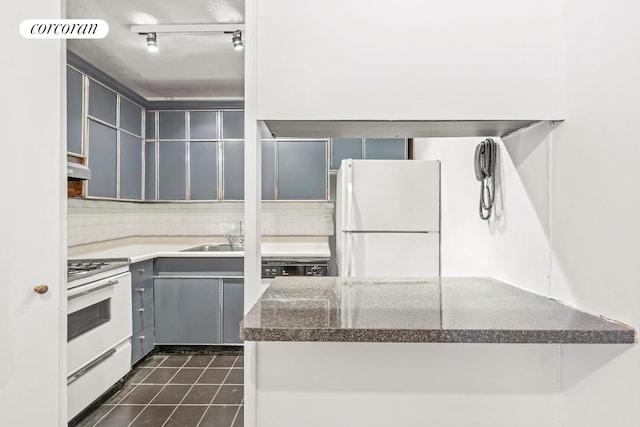300 E 40th St Unit 7P, New York City, NY 10016 - kitchen with white appliances, gray cabinets, tasteful backsplash, and under cabinet range hood