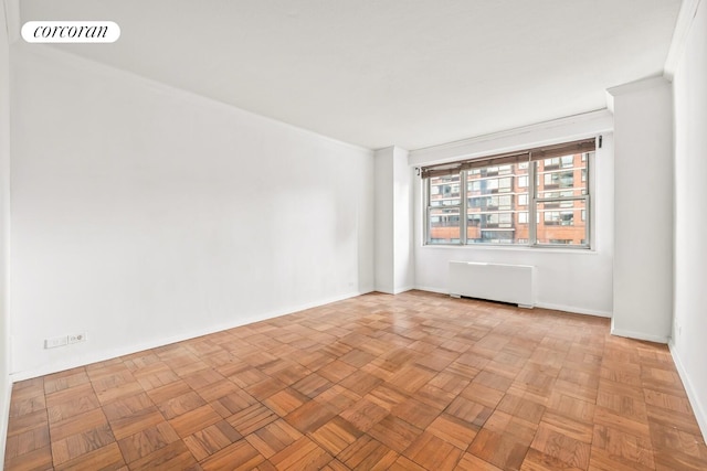 300 E 40th St Unit 7P, New York City, NY 10016 - empty room featuring radiator heating unit and baseboards