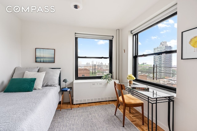193 Clinton Ave Unit 9D, New York City, NY 11205 - bedroom featuring multiple windows, a city view, and radiator heating unit