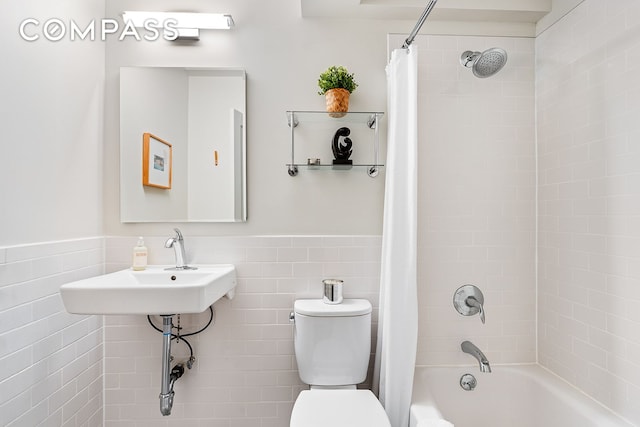 193 Clinton Ave Unit 9D, New York City, NY 11205 - full bath featuring shower / bath combo, tile walls, and a wainscoted wall
